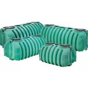 The image shows NexGen D2 septic tanks in various sizes and green colors.